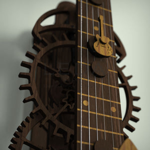 Close up view of gears with guitars on the insides, and guitar seconds hand