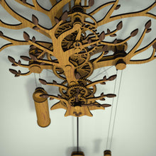 Load image into Gallery viewer, Tree Of Life wooden pendulum wall clock, top view showing wooden gear train and walnut leaves