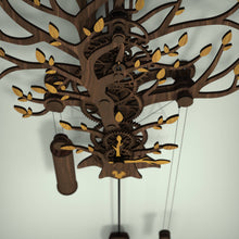 Load image into Gallery viewer, Tree Of Life wooden pendulum wall clock, top view showing wooden gear train and oak leaves